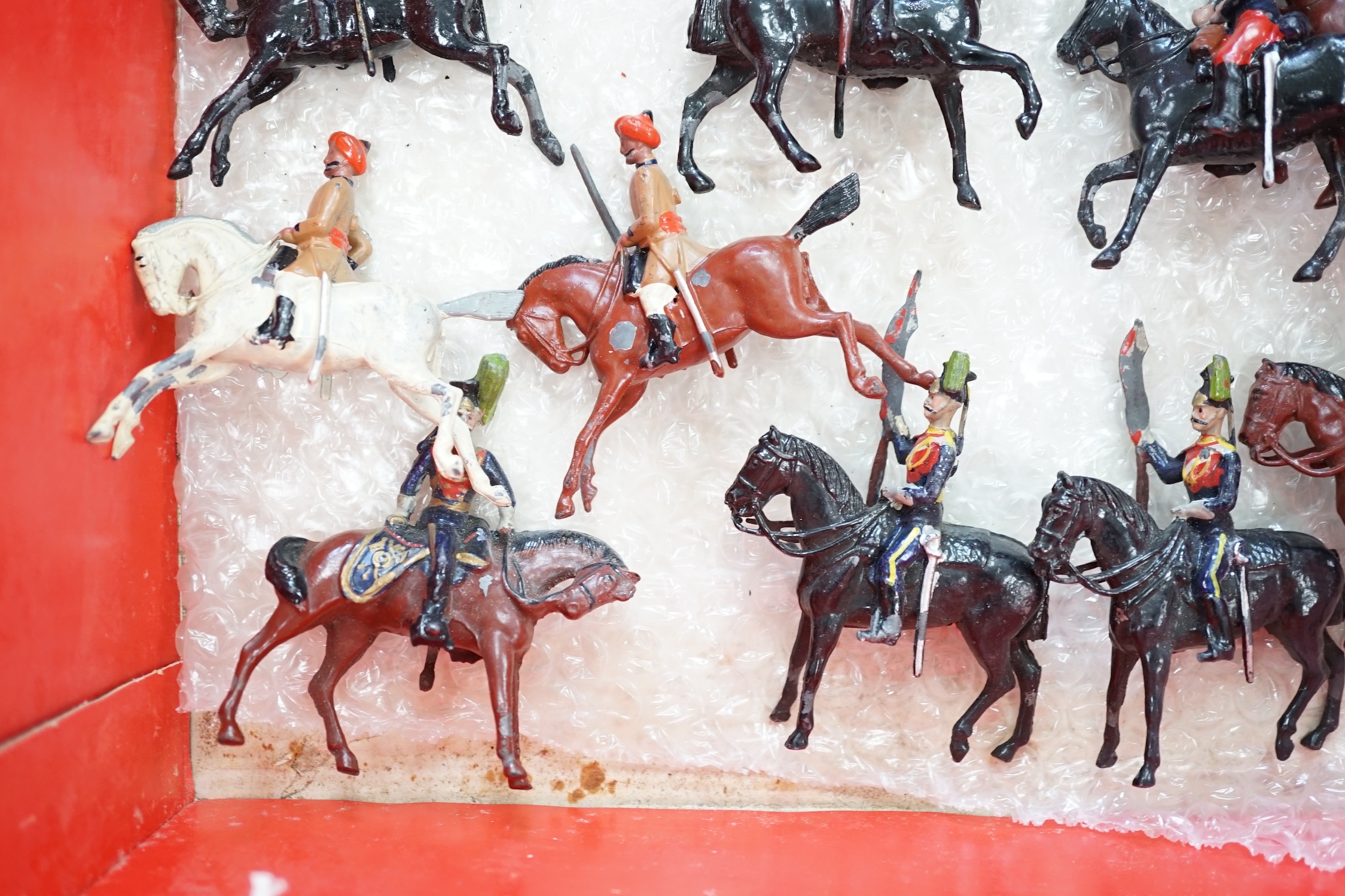 Twenty-six early twentieth century Britains, etc. cavalry soldiers including; fifteen Hussars, Indian cavalry, Royal Lancers, etc.